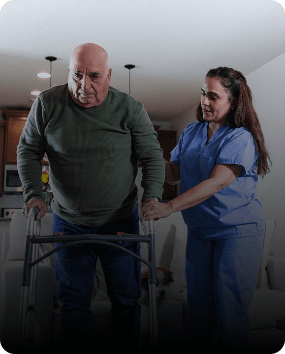 Elderly man assisted by caregiver