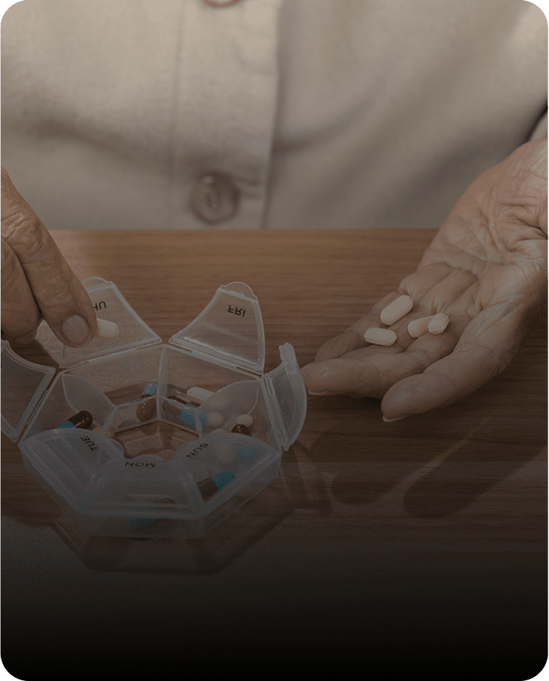 Hands sorting daily medication
